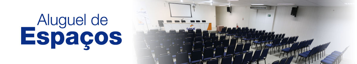 Descrição da imagem. A imagem é uma montagem formada por uma foto do fundo com vista superior de um auditório vazio,  do lado direito, com as laterais esfumaçadas de branco e do lado esquerdo, fundo branco e em letras azuis Aluguel de Espaços. Fim da descrição.